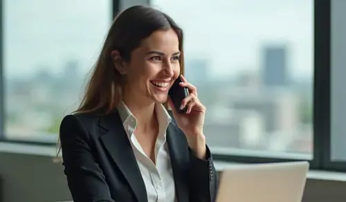 A smiling lawyer in a suit talks on the phone in a glassed-in office. Bigle CLM article on contract management.