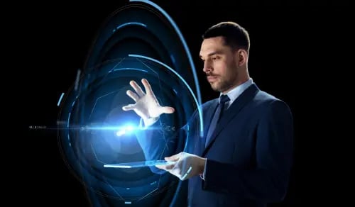 An Inhouse lawyer in a suit against a dark background controls a beam of light with his hand while holding a tablet. Bigle Legal CLM article on AI.