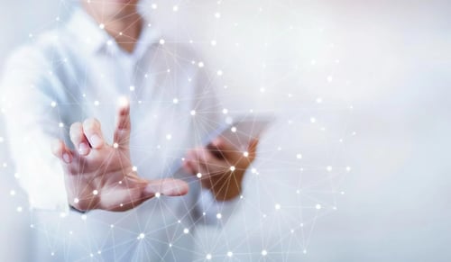 Man holds a tablet and touches a dot hologram