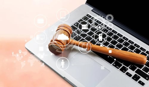 Judge's gavel on a laptop. Bigle Legal CLM article on AI and justice.