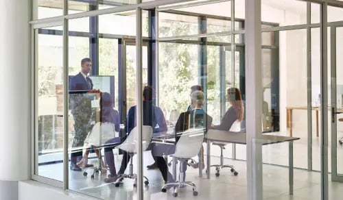 Legal team gathered in a glass office. Article by Bigle Legal CLM.