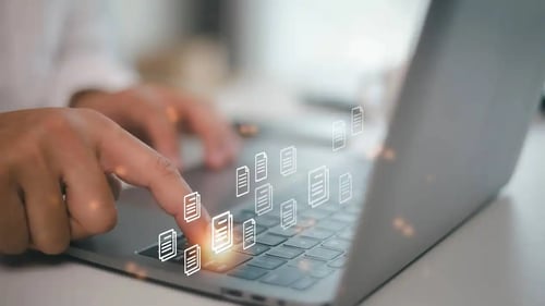 Lawyers hands typing on a laptop computer. Bigle Legals CLM software.