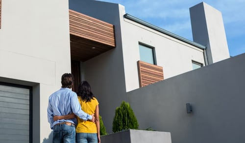 Happy couple contemplates a house. Bigle Legal CLM interview with API Cat.