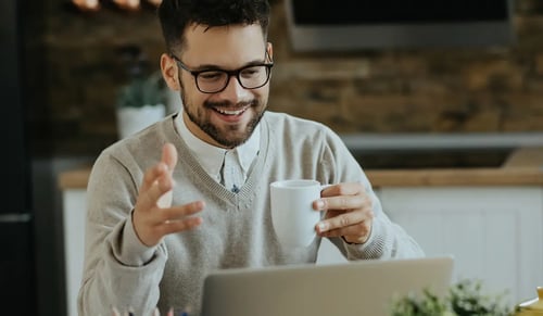 Smiling man has a conversation with his teleworking team