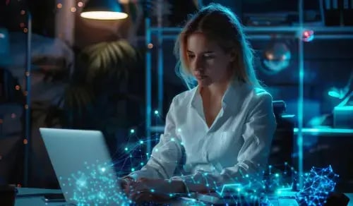 Young lawyer works at her computer, surrounded by a halo of blue dots. Bigle Legal article on AI and CLM.