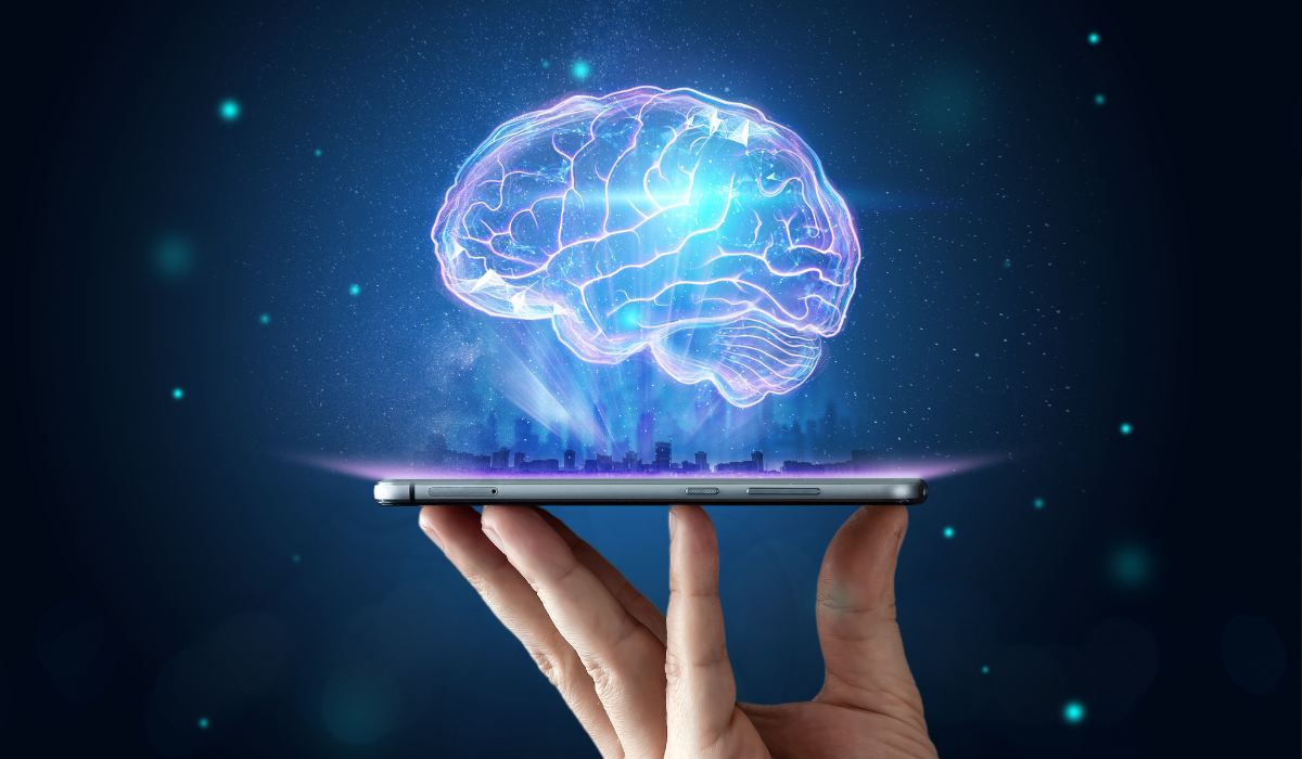 Hand holds a tablet from which a hologram of a brain appears. Article on machine learning by Bigle Legal.