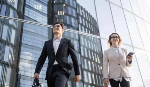 In-house lawyers in suits walk outside their office. Bigle Legal article on legal tech trends.
