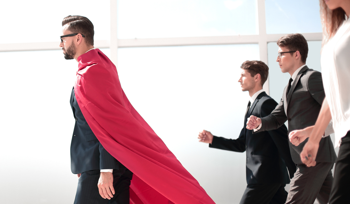 Lawyer in red superhero cape advances at the head of his team. Bigle Legal article on legal tech.
