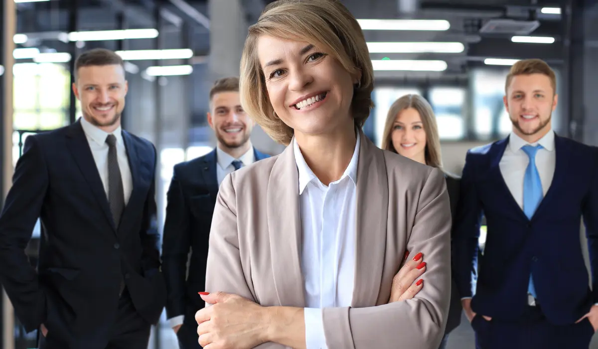 Lawyer smiles with her arms crossed in front of her team. Article by Bigle Legal.