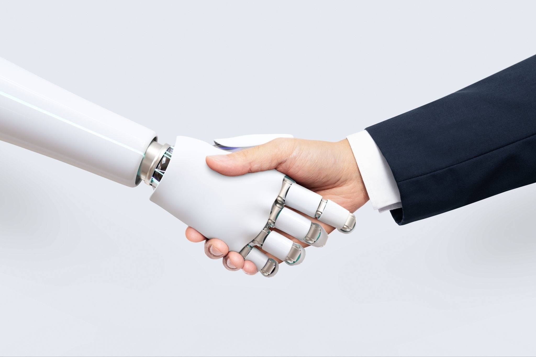 Las manos de un abogado y un robot con inteligencia artificial estrechándose en señal de colaboración.